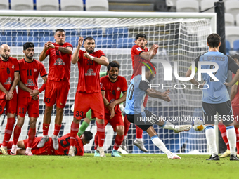 Tractor SC players block a free kick by Farid Boulaya of Al Wakrah SC during the AFC Champions League football match between Al Wakrah SC an...