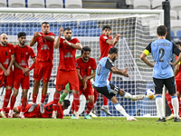 Tractor SC players block a free kick by Farid Boulaya of Al Wakrah SC during the AFC Champions League football match between Al Wakrah SC an...