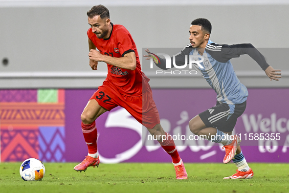 Khaled Mohammed M Saleh of Al Wakrah SC battles for the ball with Sokol Cikalleshi of Tractor SC during the AFC Champions League football ma...