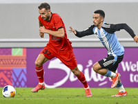 Khaled Mohammed M Saleh of Al Wakrah SC battles for the ball with Sokol Cikalleshi of Tractor SC during the AFC Champions League football ma...