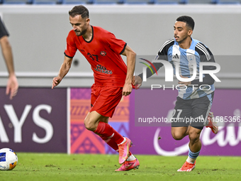 Khaled Mohammed M Saleh of Al Wakrah SC battles for the ball with Sokol Cikalleshi of Tractor SC during the AFC Champions League football ma...