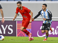 Khaled Mohammed M Saleh of Al Wakrah SC battles for the ball with Sokol Cikalleshi of Tractor SC during the AFC Champions League football ma...