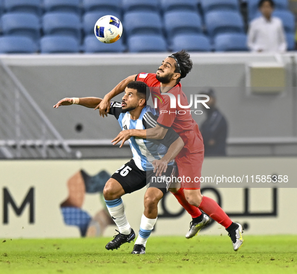 Abdelaziz Khaled S Metwalli (L) of Al Wakrah SC battles for the ball with Seyed Mehdi Hosseini of Tractor SC during the AFC Champions League...