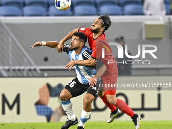 Abdelaziz Khaled S Metwalli (L) of Al Wakrah SC battles for the ball with Seyed Mehdi Hosseini of Tractor SC during the AFC Champions League...