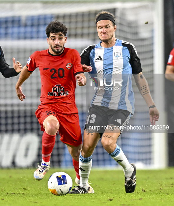 Alexander Scholz (R) of Al Wakrah SC battles for the ball with Mahdi Hashemnezhad of Tractor SC during the AFC Champions League football mat...