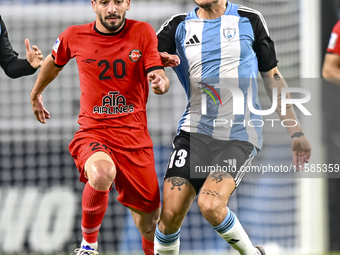 Alexander Scholz (R) of Al Wakrah SC battles for the ball with Mahdi Hashemnezhad of Tractor SC during the AFC Champions League football mat...