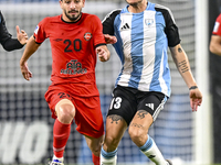 Alexander Scholz (R) of Al Wakrah SC battles for the ball with Mahdi Hashemnezhad of Tractor SC during the AFC Champions League football mat...