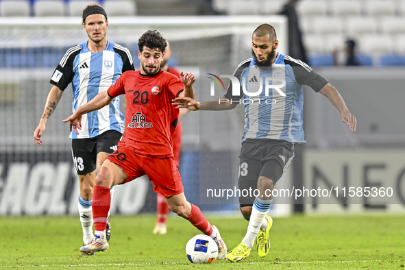 Aissa Belal Laidouni of Al Wakrah SC battles for the ball with Mahdi Hashemnezhad of Tractor SC during the AFC Champions League football mat...