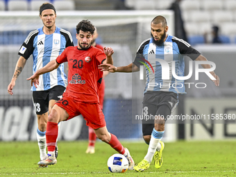 Aissa Belal Laidouni of Al Wakrah SC battles for the ball with Mahdi Hashemnezhad of Tractor SC during the AFC Champions League football mat...