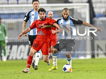 Aissa Belal Laidouni of Al Wakrah SC battles for the ball with Mahdi Hashemnezhad of Tractor SC during the AFC Champions League football mat...