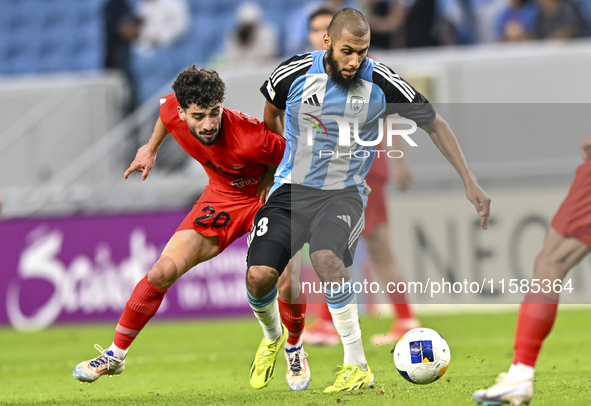 Aissa Belal Laidouni of Al Wakrah SC battles for the ball with Mahdi Hashemnezhad of Tractor SC during the AFC Champions League football mat...