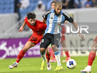 Aissa Belal Laidouni of Al Wakrah SC battles for the ball with Mahdi Hashemnezhad of Tractor SC during the AFC Champions League football mat...