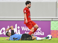 Tameem Almuhaza (bottom) of Al Wakrah SC battles for the ball with Mahdi Hashemnezhad of Tractor SC during the AFC Champions League football...