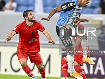 Ricardo Jorge Gomes of Al Wakrah SC battles for the ball with Aref Gholami of Tractor SC during the AFC Champions League football match betw...