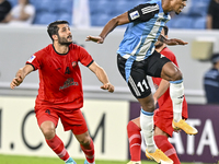 Ricardo Jorge Gomes of Al Wakrah SC battles for the ball with Aref Gholami of Tractor SC during the AFC Champions League football match betw...