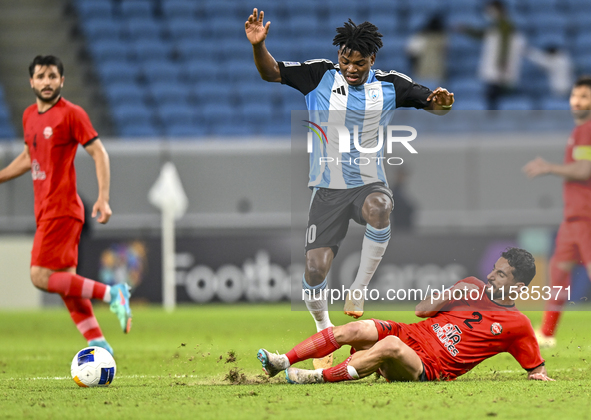 Jacinto Dala of Al Wakrah SC battles for the ball with Mehdi Shiri of Tractor SC during the AFC Champions League football match between Qata...