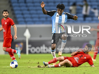 Jacinto Dala of Al Wakrah SC battles for the ball with Mehdi Shiri of Tractor SC during the AFC Champions League football match between Qata...