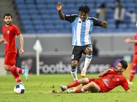 Jacinto Dala of Al Wakrah SC battles for the ball with Mehdi Shiri of Tractor SC during the AFC Champions League football match between Qata...