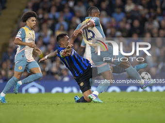 Lautaro Martinez #10 of Inter Milan tackles Manuel Akanji #25 of Manchester City F.C. during the UEFA Champions League League Stage match be...