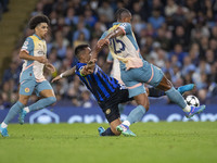 Lautaro Martinez #10 of Inter Milan tackles Manuel Akanji #25 of Manchester City F.C. during the UEFA Champions League League Stage match be...