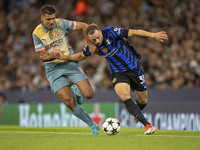 Carlos Augusto #30 of Inter Milan tackles Rodri #16 of Manchester City F.C. during the UEFA Champions League League Stage match between Manc...