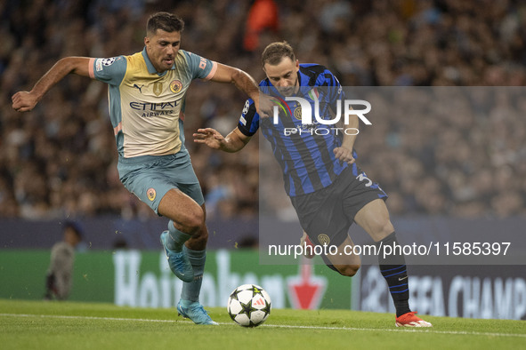 Carlos Augusto #30 of Inter Milan tackles Rodri #16 of Manchester City F.C. during the UEFA Champions League League Stage match between Manc...