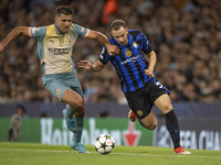 Carlos Augusto #30 of Inter Milan tackles Rodri #16 of Manchester City F.C. during the UEFA Champions League League Stage match between Manc...