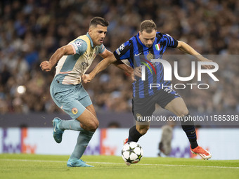 Carlos Augusto #30 of Inter Milan tackles Rodri #16 of Manchester City F.C. during the UEFA Champions League League Stage match between Manc...