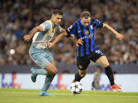 Carlos Augusto #30 of Inter Milan tackles Rodri #16 of Manchester City F.C. during the UEFA Champions League League Stage match between Manc...