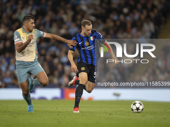 Carlos Augusto #30 of Inter Milan tackles Rodri #16 of Manchester City F.C. during the UEFA Champions League League Stage match between Manc...