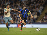 Carlos Augusto #30 of Inter Milan tackles Rodri #16 of Manchester City F.C. during the UEFA Champions League League Stage match between Manc...