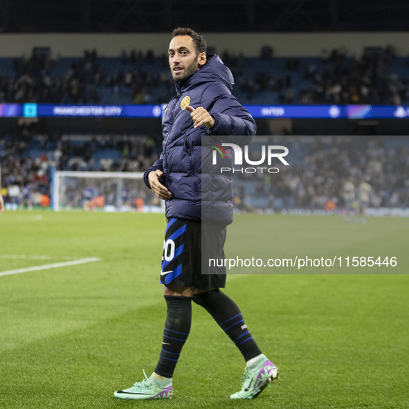 Hakan Calhanoglu #20 of Inter Milan salutes the fans at full time during the UEFA Champions League League Stage match between Manchester Cit...