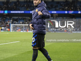 Hakan Calhanoglu #20 of Inter Milan salutes the fans at full time during the UEFA Champions League League Stage match between Manchester Cit...