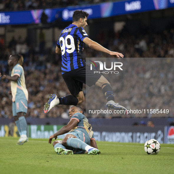 Mehdi Taremi #99 of Inter Milan is tackled by Manuel Akanji #25 of Manchester City F.C. during the UEFA Champions League League Stage match...