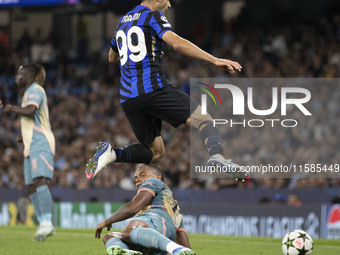 Mehdi Taremi #99 of Inter Milan is tackled by Manuel Akanji #25 of Manchester City F.C. during the UEFA Champions League League Stage match...