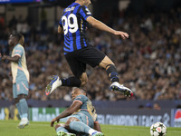 Mehdi Taremi #99 of Inter Milan is tackled by Manuel Akanji #25 of Manchester City F.C. during the UEFA Champions League League Stage match...