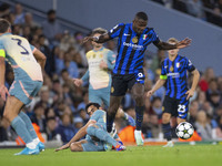 Marcus Thuram #9 of Inter Milan is tackled by Ilkay Gundogan #19 of Manchester City F.C during the UEFA Champions League League Stage match...