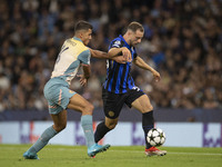 Carlos Augusto #30 of Inter Milan is tackled by Rodri #16 of Manchester City F.C. during the UEFA Champions League League Stage match betwee...