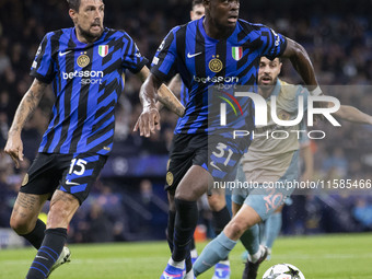 Yann Aurel Bisseck #31 of Inter Milan is in action during the UEFA Champions League League Stage match between Manchester City and Football...