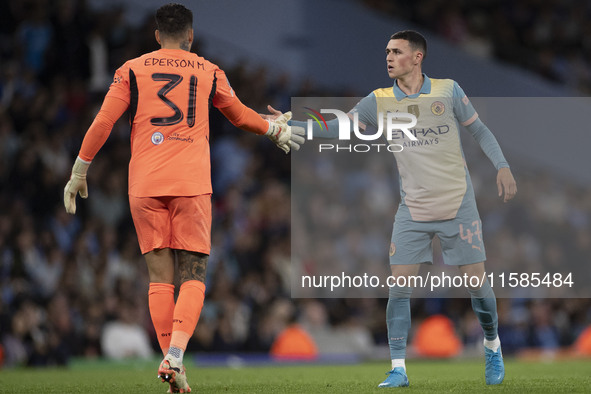 Ederson shakes hands with Phil Foden #47 of Manchester City F.C. during the UEFA Champions League League Stage match between Manchester City...