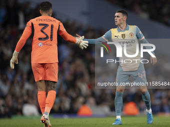 Ederson shakes hands with Phil Foden #47 of Manchester City F.C. during the UEFA Champions League League Stage match between Manchester City...