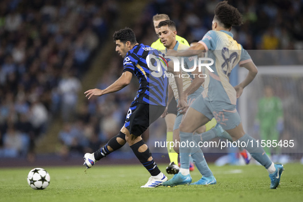 Mehdi Taremi #99 of Inter Milan is in action during the UEFA Champions League Group Stage match between Manchester City and Football Club In...