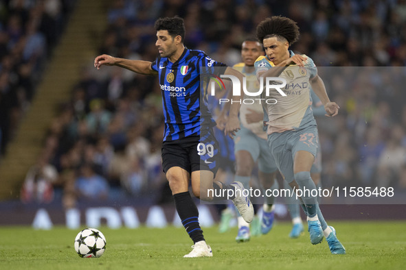 Mehdi Taremi #99 of Inter Milan is in action during the UEFA Champions League Group Stage match between Manchester City and Football Club In...