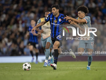 Mehdi Taremi #99 of Inter Milan is in action during the UEFA Champions League Group Stage match between Manchester City and Football Club In...