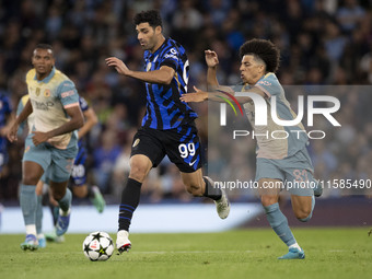 Mehdi Taremi #99 of Inter Milan is in action during the UEFA Champions League Group Stage match between Manchester City and Football Club In...