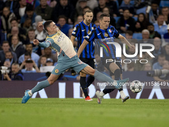 Phil Foden #47 of Manchester City F.C. tackles the opponent during the UEFA Champions League League Stage match between Manchester City and...