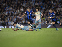 Henrikh Mkhitaryan #22 of Inter Milan is tackled by Rodri #16 of Manchester City F.C. during the UEFA Champions League League Stage match be...