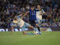 Henrikh Mkhitaryan #22 of Inter Milan is tackled by Rodri #16 of Manchester City F.C. during the UEFA Champions League League Stage match be...