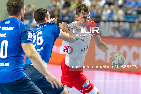 Przemyslaw Krajewski and Stanislav Kasparek are playing during the  EHF Champions League Men match between  Orlen Wisla Plock and Dinamo Buc...