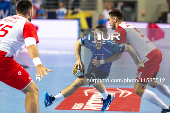 Mitja Janc and  Robert Mihai Militaru  are playing during the  EHF Champions League Men match between  Orlen Wisla Plock and Dinamo Bucurest...